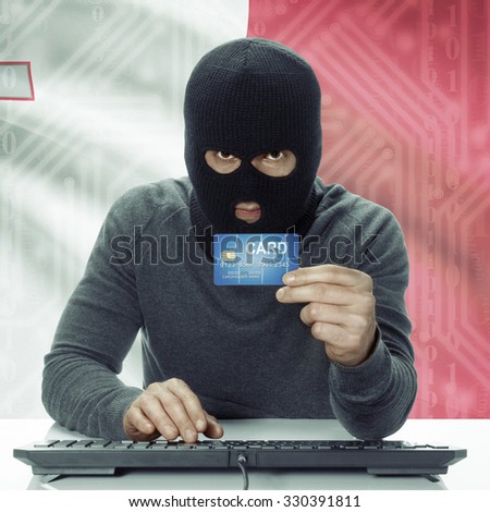 Dark-skinned hacker with credit card in hand and flag on background - Malta