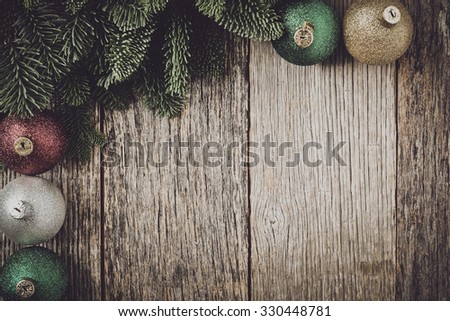 Christmas Pine Needle and Ornaments on a Rustic Wood Background
