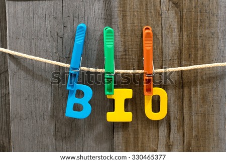 word bio fasten clothespins on a rope behind a wooden background