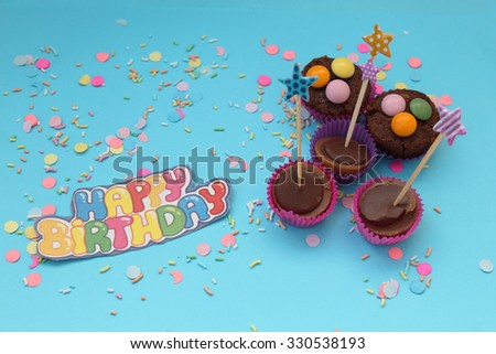 Cupcakes on blue confetti background - happy birthday card