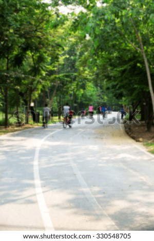 People ride bicycles in park : Blurred background