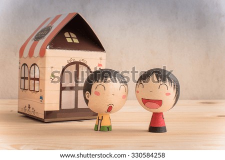 Vintage retro picture style -  Boy and girl dolls smile with house