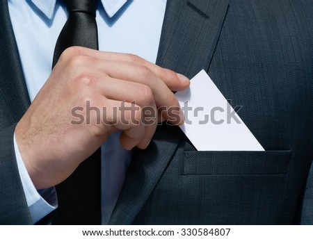 Close up of business man hand who takes out business card from the pocket of business suit