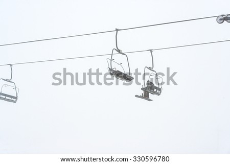 a man ride the ski chair lift up to the mountain in ski resort in Washington,USA.