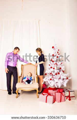 Christmas Family Portrait In Home Holiday Living Room, Kids and Baby With Present Gift Box, House Decorating By Xmas Tree Candles Garland