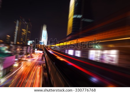 Abstract acceleration speed motion light Blur from Sky Train at night in modern city (background) Royalty-Free Stock Photo #330776768