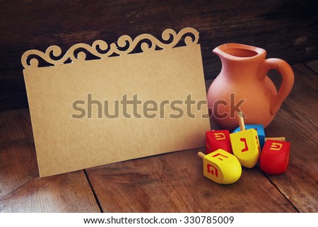 image of jewish holiday Hanukkah and wooden dreidels (spinning top) with empty card for adding text
