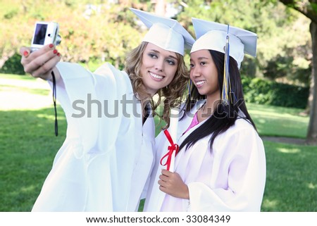 Pretty young women at graduation taking a picture