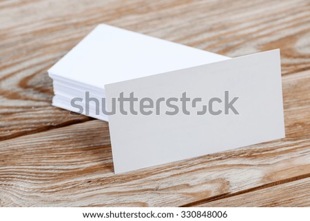 White blank business visit card, gift, ticket, pass, present close up on wooden background. Copy space Blank corporate identity package business card.