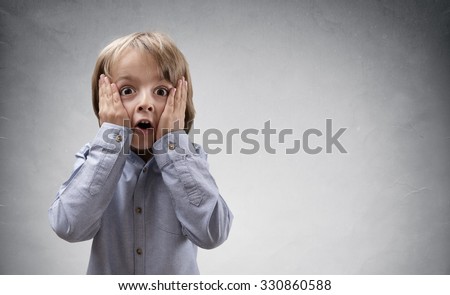 Shocked and surprised boy with copy space concept for amazement, astonishment, making a mistake, stunned and speechless or back to school Royalty-Free Stock Photo #330860588