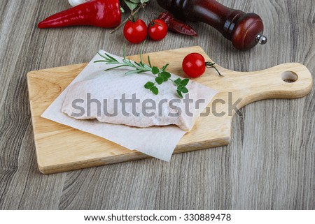 Raw duck breast with rosemary - ready for cooking
