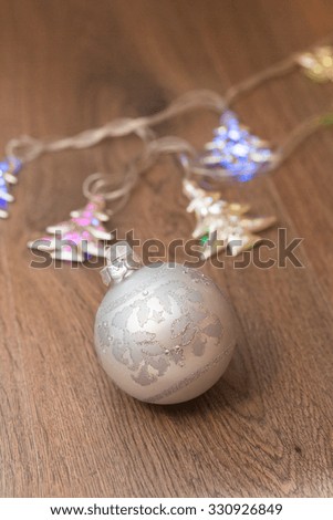 wooden table with defocused christmas  lights and glass balls