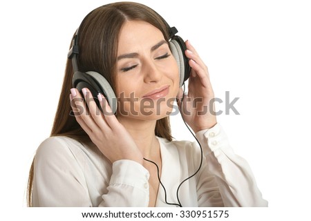 Happy beautiful girl listening to music in headphones