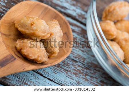 Close up shot of Thai snack, Pun Sib dried shredded pork flavored on wood table, Selltected focus Royalty-Free Stock Photo #331014332
