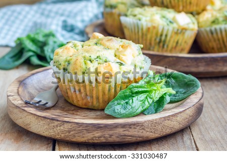 Snack muffins with spinach and feta cheese on a wooden plate Royalty-Free Stock Photo #331030487