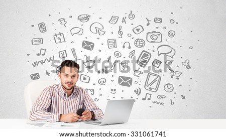 Good-looking young businessman with all kind of hand-drawn media icons in background