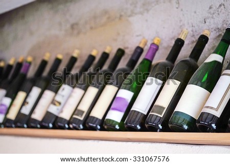 The image of  bottles of  wine on a wooden shelf in the restaurant