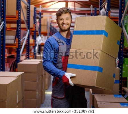 Porter carrying boxes in a warehouse 
