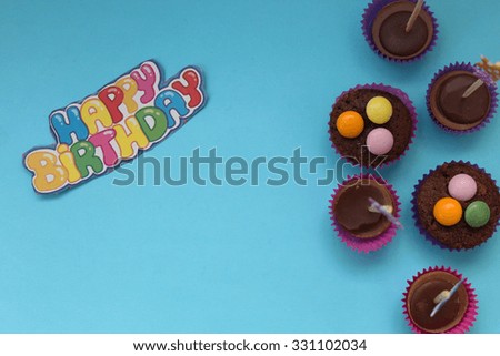 Cupcakes on blue background - happy birthday card