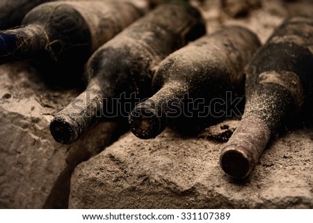 Old wine bottles on a stone step, a cave Royalty-Free Stock Photo #331107389