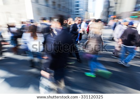 picture with creative blur and zoom effect made by camera of commuters walking on the street