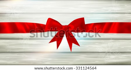 Decorative red ribbon and bow on a background of white painted rustic boards with copyspace. EPS 10 vector file included