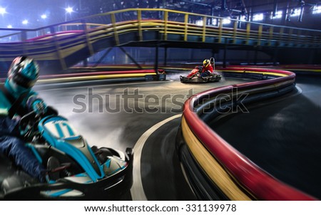 Two cart racers are racing on the grand track motion Royalty-Free Stock Photo #331139978