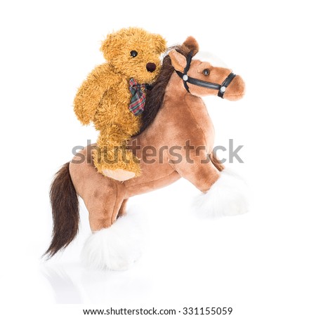 Teddy bear riding a horses on white background