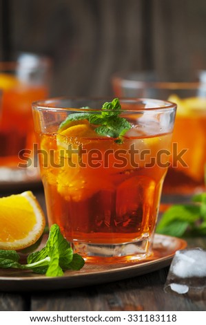 Glass of aperol with ice, orange and mint, selective focus