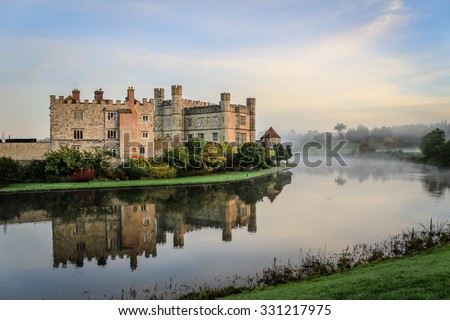 Leeds Castle, Kent, England, at dawn, with mist on the lake. Royalty-Free Stock Photo #331217975