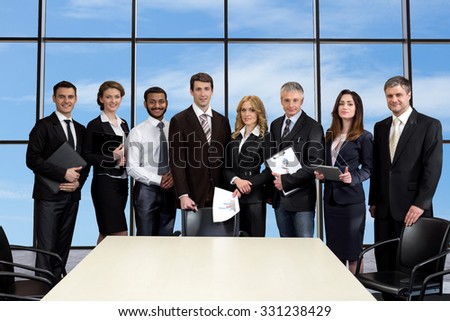 Business meeting in skyscraper. Business colleagues on the background of sky. Managers on the background of window.