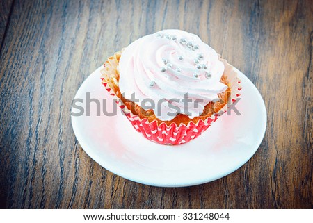 Cake with Cream, Cupcake on Woody Background. Studio Photo