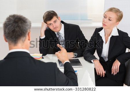 Group Of Three Businesspeople Having Argument At Workplace Royalty-Free Stock Photo #331280822