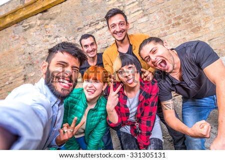 Group of friends having fun in a cocktail bar and taking a selfie - Young students partying together and taking picture - Concepts about fun,youth,technologies and nightlife