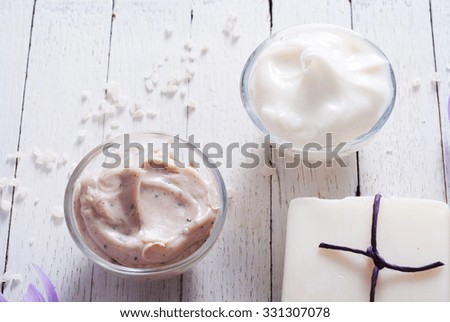 cosmetic cream variations, soap and autumn crocus herbal flower on white wooden table