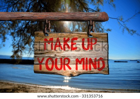 Make up your mind motivational phrase sign on old wood with blurred background