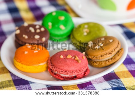 Macaron in plate  on color  tablecloth
