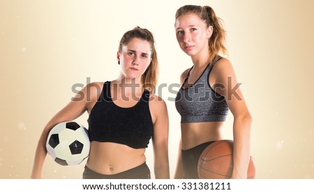 Friends holding soccer ball and basket ball