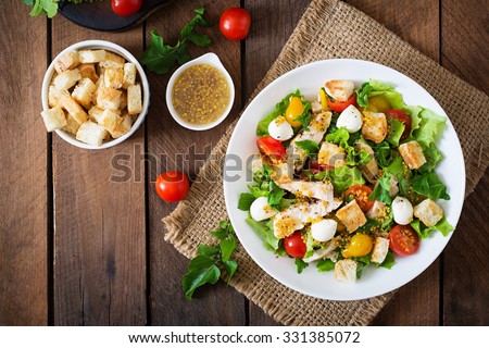 Salad with chicken, mozzarella and cherry tomatoes. Top view Royalty-Free Stock Photo #331385072