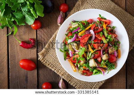 Salad  baked eggplant and fresh tomatoes. Top view Royalty-Free Stock Photo #331385141