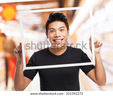 cool chinese man holding a black frame