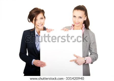Two businesswomen showing white empty banner.