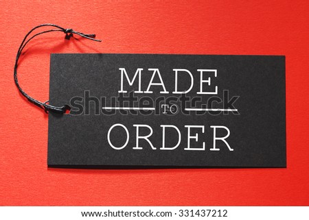 Made to Order text on a black tag on a red paper background