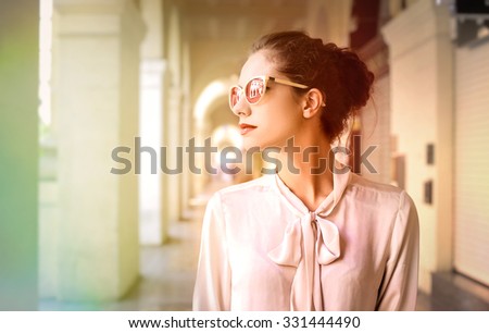Classy woman walking in the city Royalty-Free Stock Photo #331444490