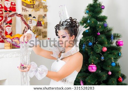 Christmas Winter Fashion Model Girl with hairstyle decorated glass crown. make up. Beauty Woman. Beautiful New Year Holiday Creative Hair style. The Snow Queen