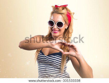 Pin-up girl making heart gesture