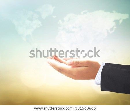 Businessman open empty hands with palms up, over blurred beautiful blue sky background.