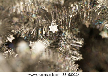 Silver tinsel Christmas decoration - close-up photo