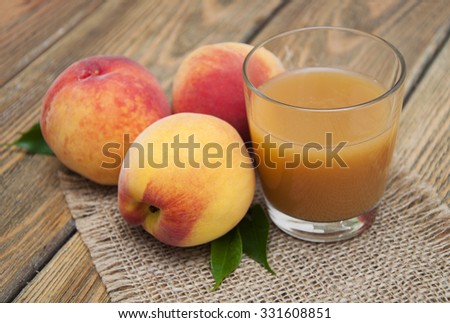 Fresh peach juice on a wooden background