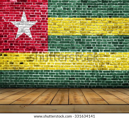 Togo flag painted on brick wall with wooden floor